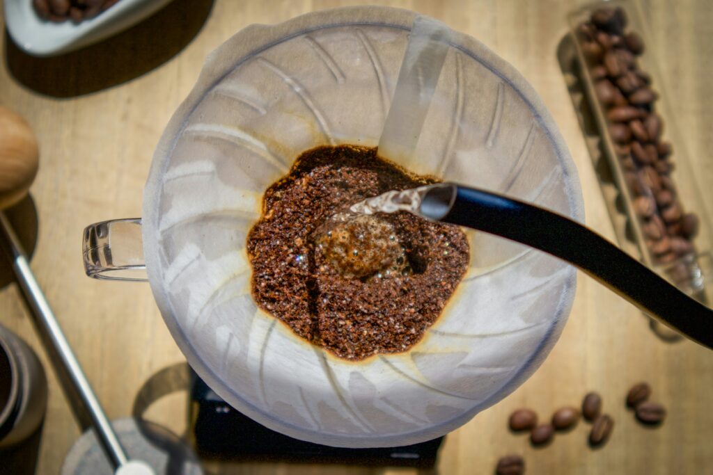 Pouring hot water over coffee grounds.