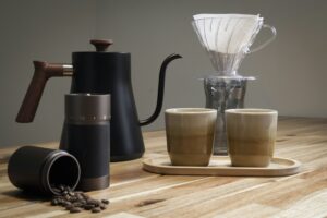Coffee brewing equipment arranged on a wooden surface.