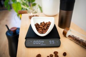 Coffee beans are being weighed on a digital scale.
